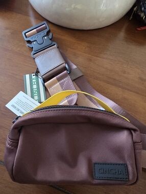Cincha Travel Belt Buddy Brown Sling Bag with Yellow Accent and Pink Strap